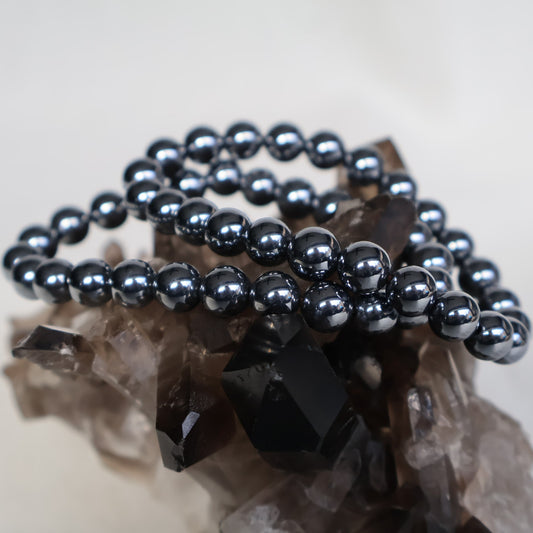 Terahertz Stone 8mm stretch bracelet with smooth metallic-grey beads and a highly reflective finish.