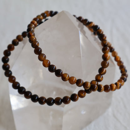 Tiger’s Eye crystal bracelet with polished 4mm round beads on a stretch fit band.