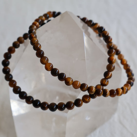 Tiger’s Eye crystal bracelet with polished 4mm round beads on a stretch fit band.