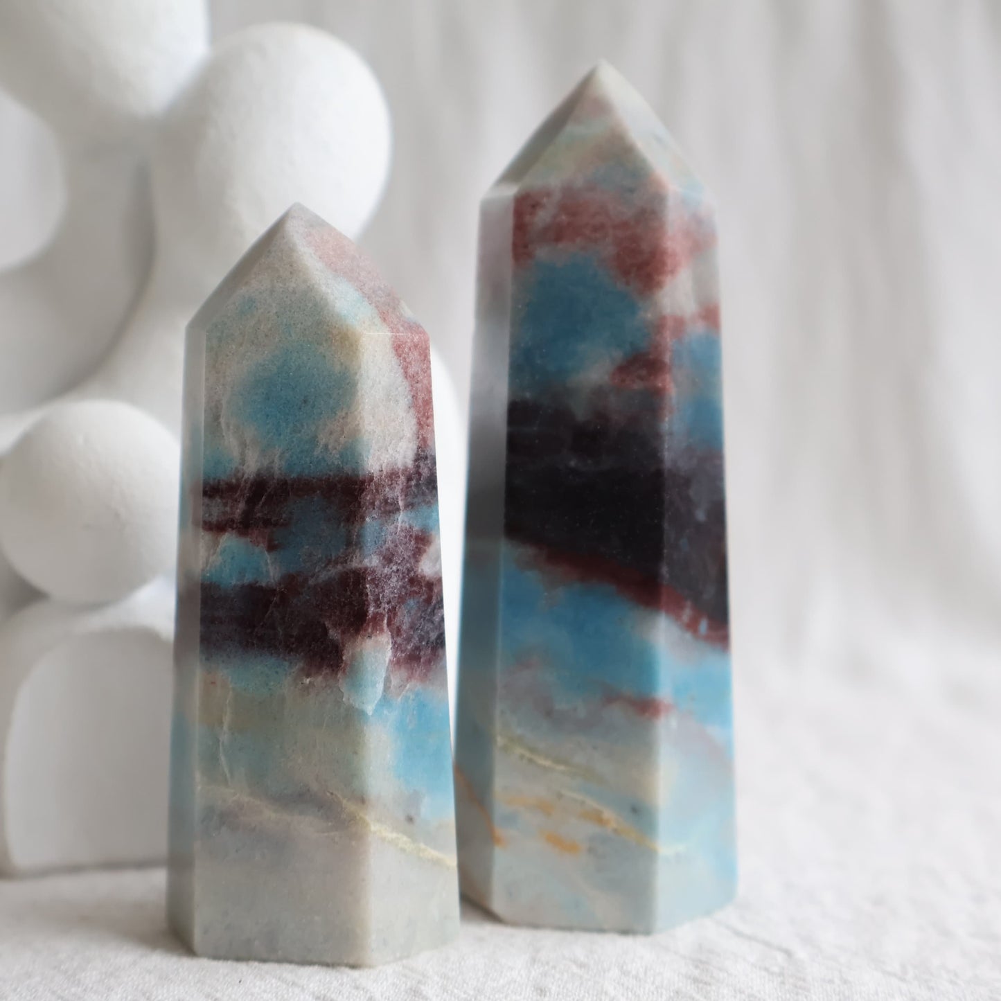Trolleite crystal towers with vivid blue, burgundy red and cream mineral patterning, polished into generator tower points