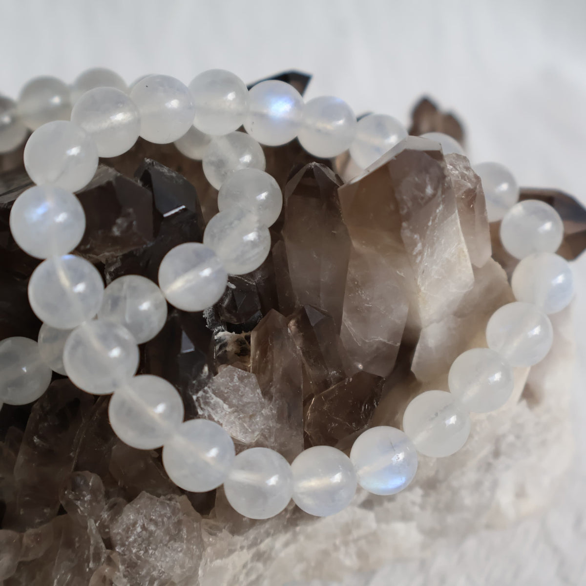 White Moonstone 8mm bead stretch bracelet with luminous white beads, natural translucency and beautiful blue flash.