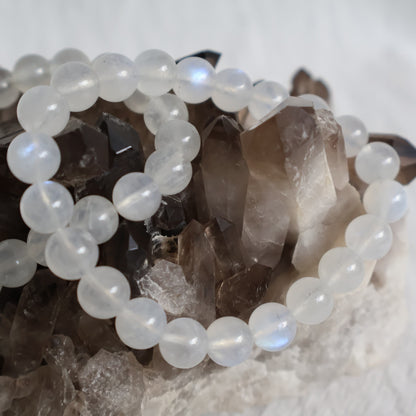 White Moonstone 8mm bead stretch bracelet with luminous white beads, natural translucency and beautiful blue flash.