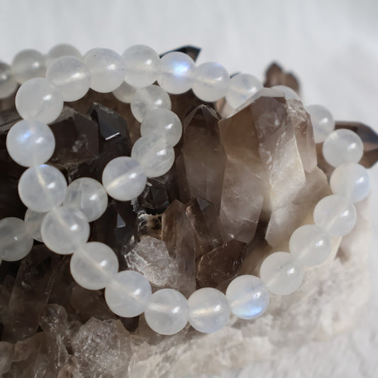 White Moonstone 8mm bead stretch bracelet with luminous white beads, natural translucency and beautiful blue flash.