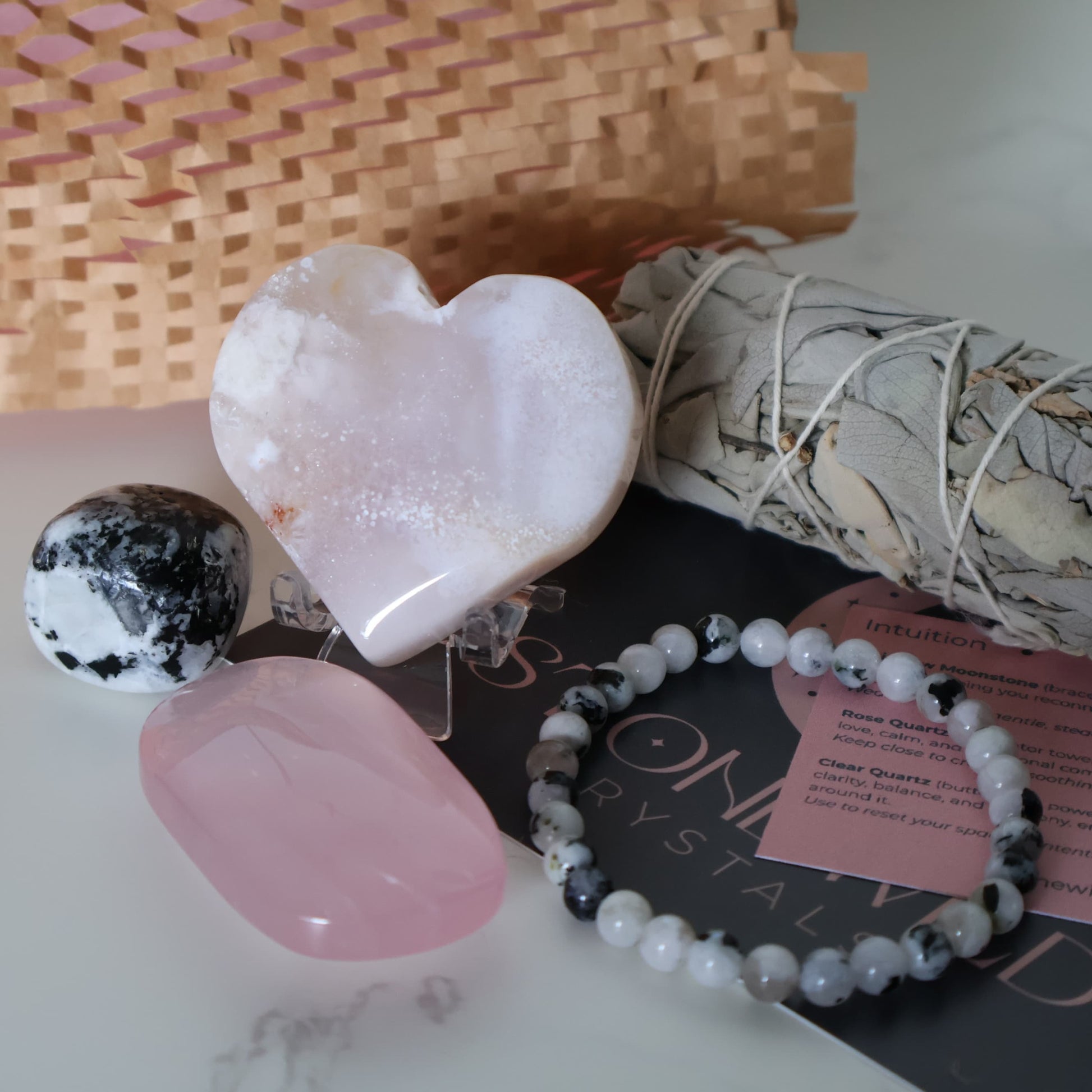 With Love Valentine’s Ritual Set gift box including Flower Agate heart on stand, Rainbow Moonstone bracelet and tumble, Rose Quartz palm stone, and sage bundle