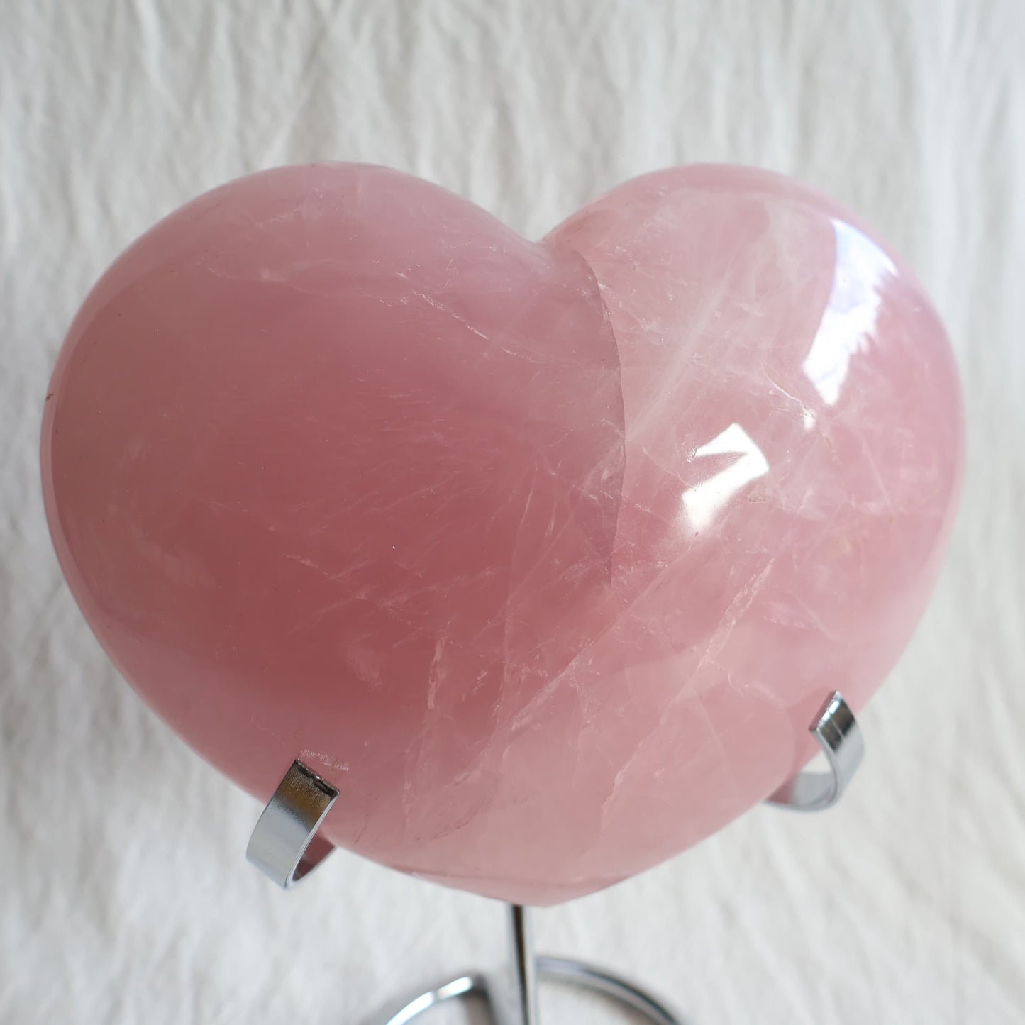 XXL rose quartz puffy heart crystal on stand with soft blush pink colouring, natural clouding and polished finish.
