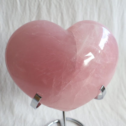 XXL rose quartz puffy heart crystal on stand with soft blush pink colouring, natural clouding and polished finish.